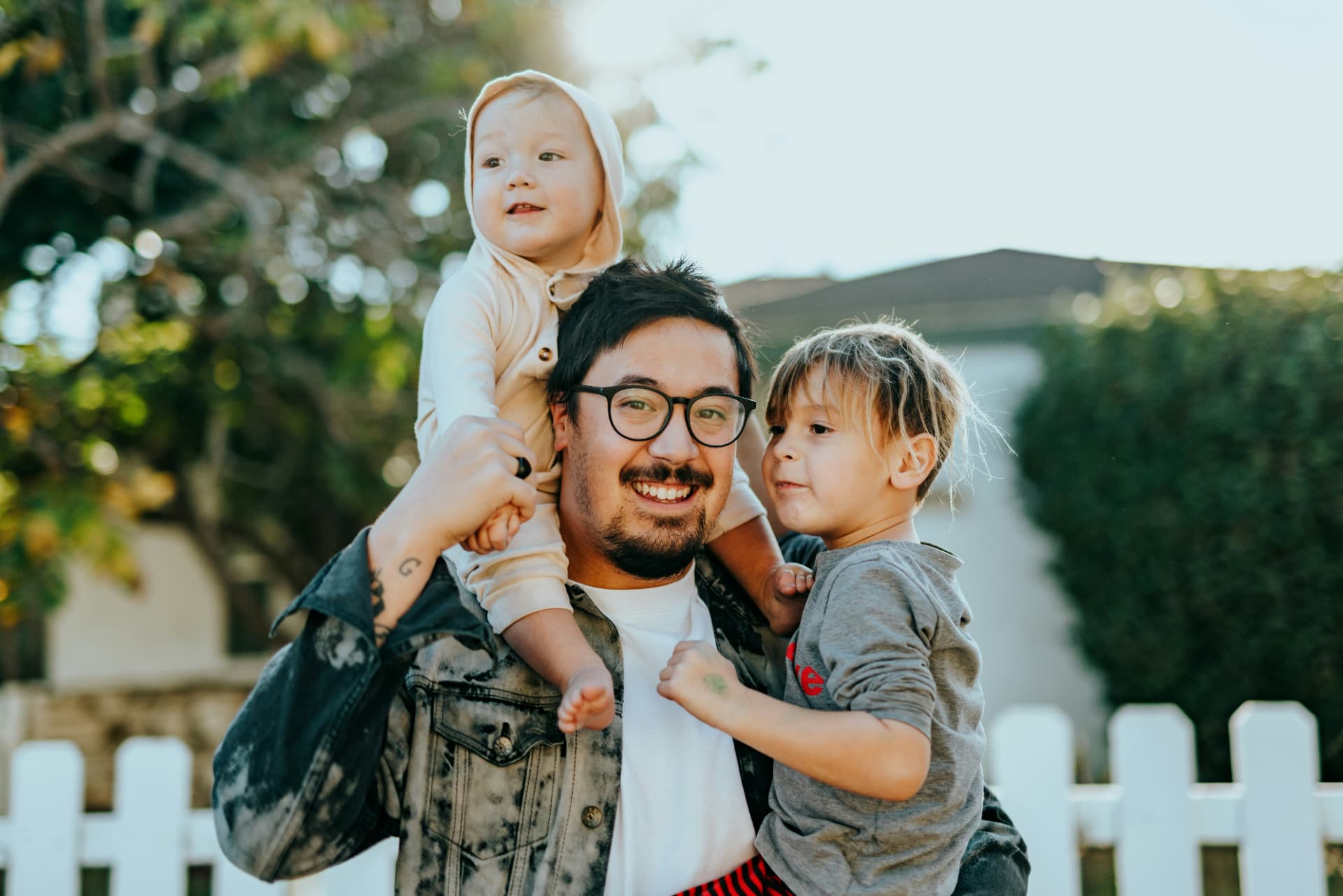 A father carrying his two children